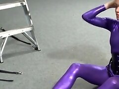 suspended in purple catsuit