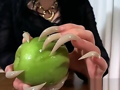 scratching an apple long nails